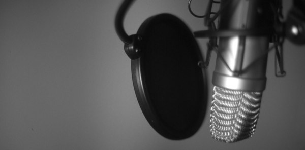 Close-up of a studio microphone with a pop filter for ADR.