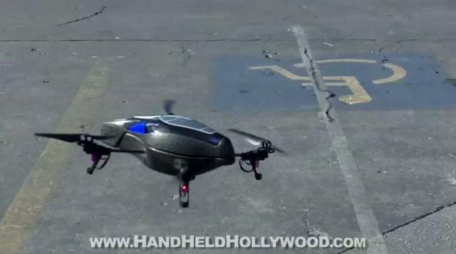 A Parrot drone hovers over the parking lot.