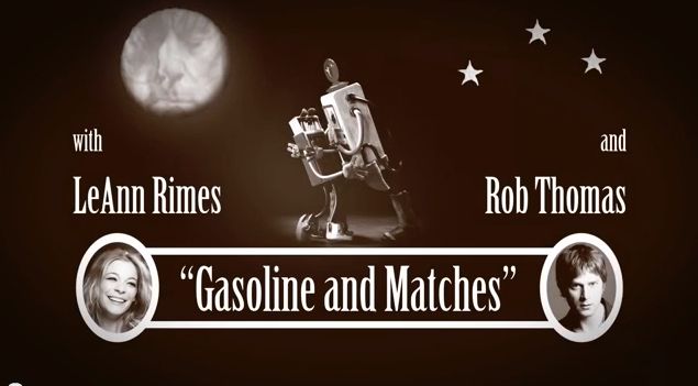 Promotional image for "gasoline and matches" featuring a robot holding a match with the names leann rimes and rob thomas.