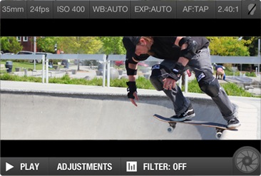A skateboarder is performing tricks at a skate park, capturing the action with an iPhone.