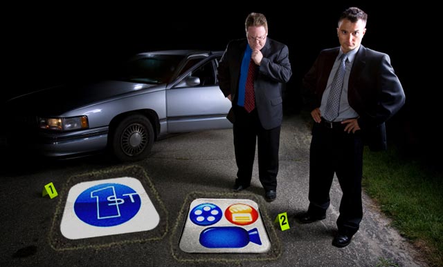 Two men in suits standing at a crime scene with evidence markers at night, capturing everything on their iMovie for iPhone.