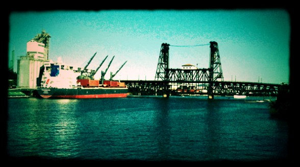 A ship is docked next to a bridge, providing a picturesque backdrop for photo opportunities.