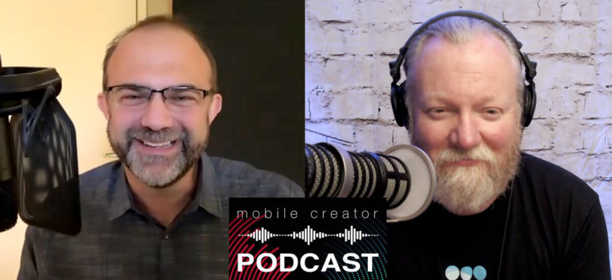 Two men recording a Mobile Creator Podcast episode, one smiling with headphones and the other with a microphone and beard.