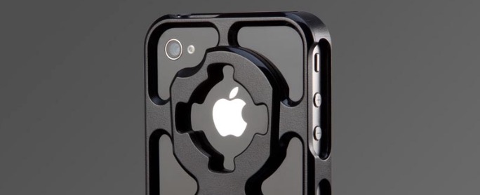 Black iPhone with a Rokform V3 skeletal-style case featuring a tripod adaptor and revealing the apple logo.