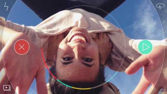 Woman smiling while seen upside down through a camera's viewfinder display, captured by the Spark video camera app.
